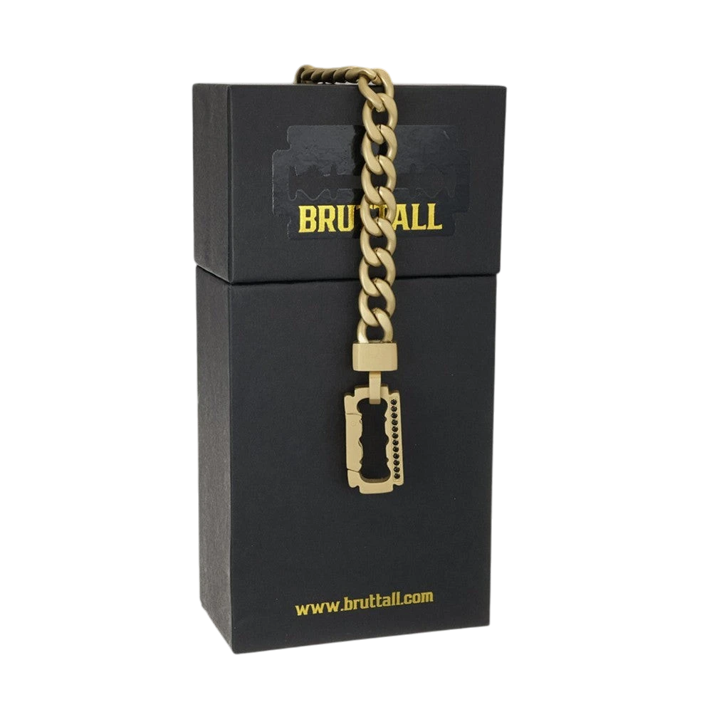 Bruttall AXIS matte gold chain bracelet with a razor blade pendant featuring Swarovski Zirconia on a black box