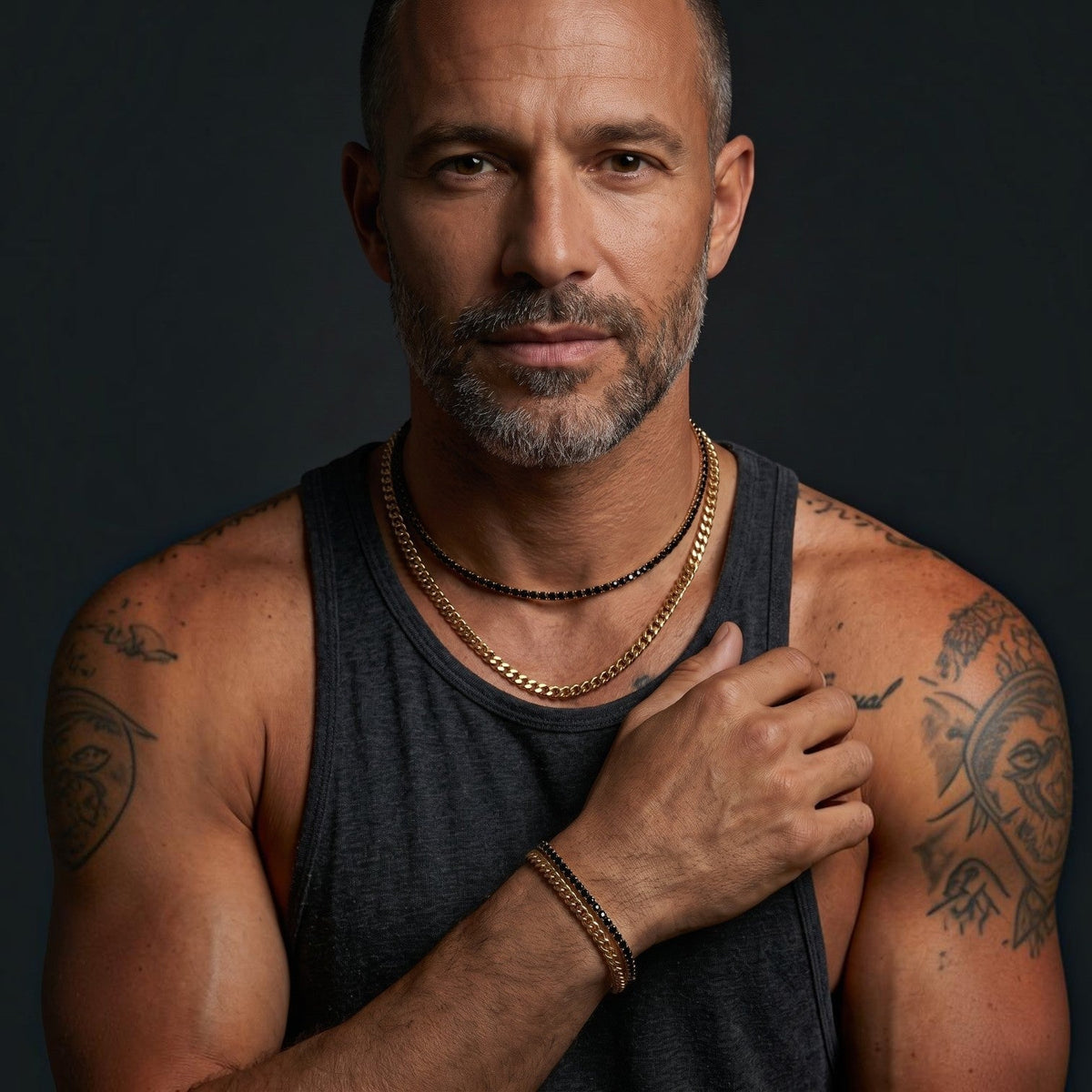 Bruttall GATE gold plated Cuban chain necklace with black Swarovski crystals worn by a man in a grey tank top.