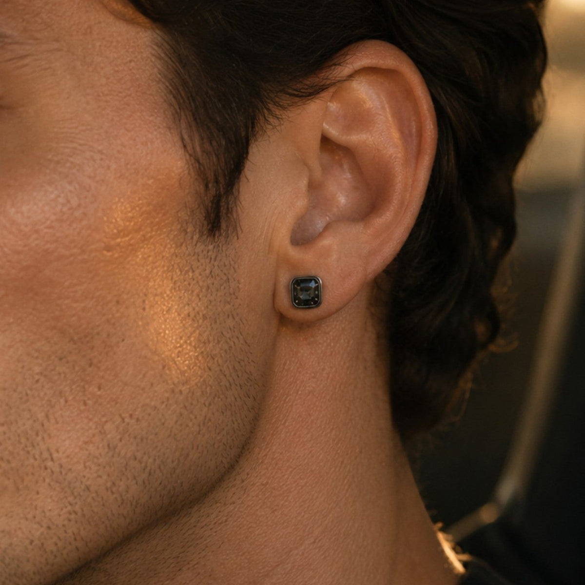 Bruttall OCTANT small single earring with a dark Swarovski crystal in an antique plated geometric setting on a man