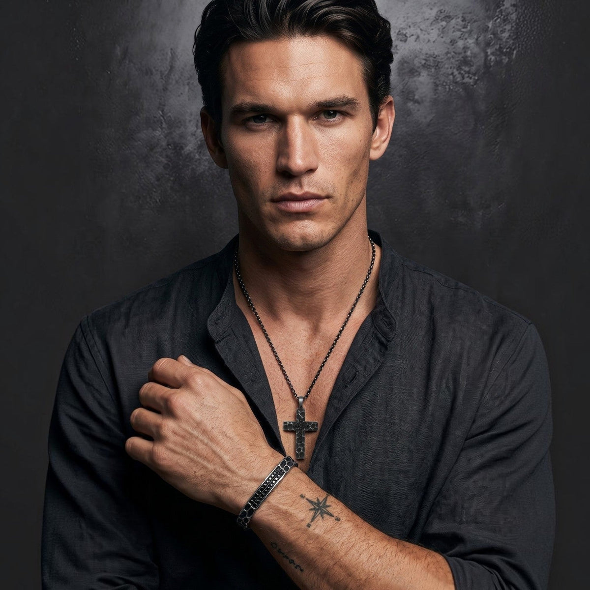 Bruttall RAW bangle with Swarovski Zirconia on a man wearing a matching cross pendant and black linen shirt