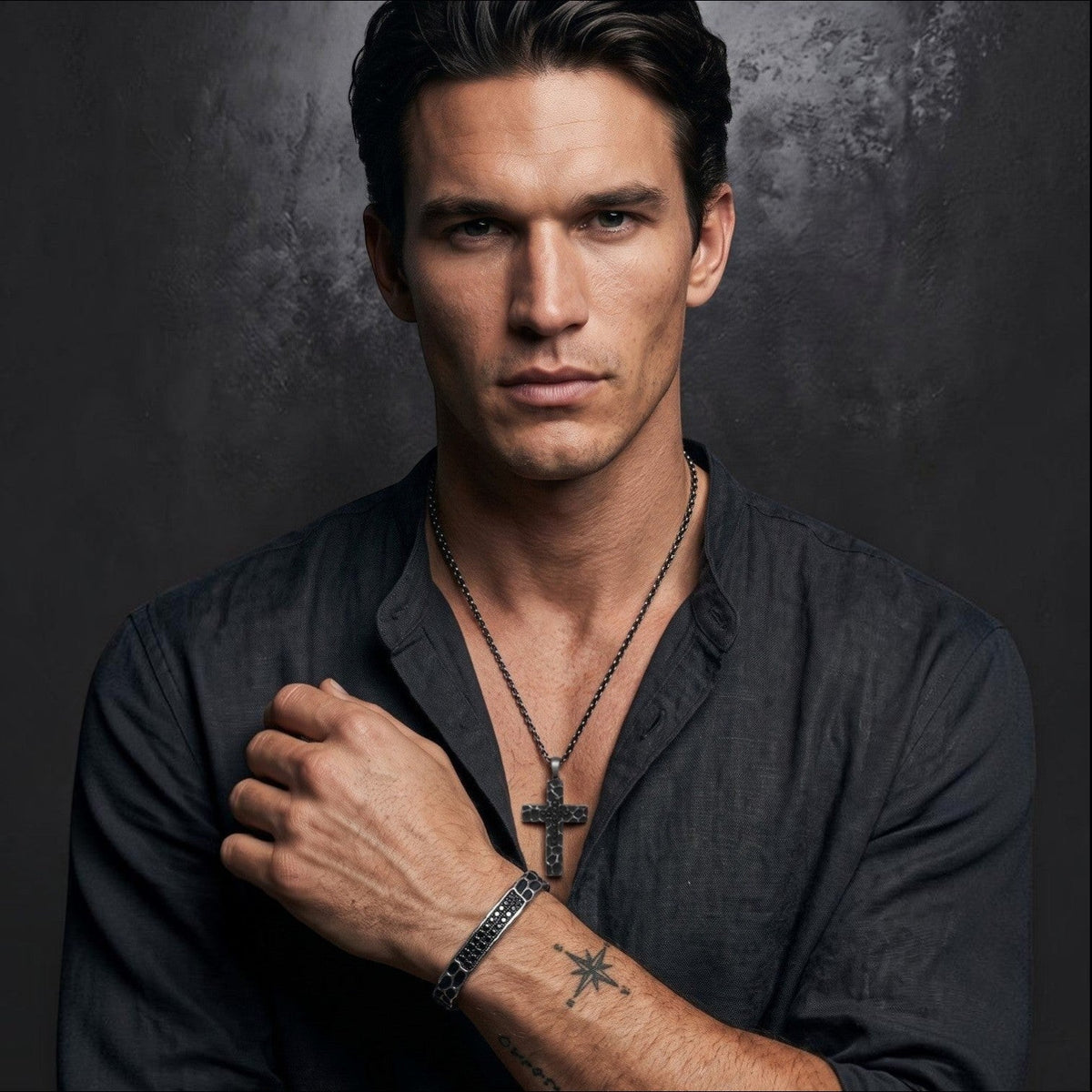 Bruttall RAW cross pendant necklace with textured antique finish and black Swarovski Zirconia worn by a man