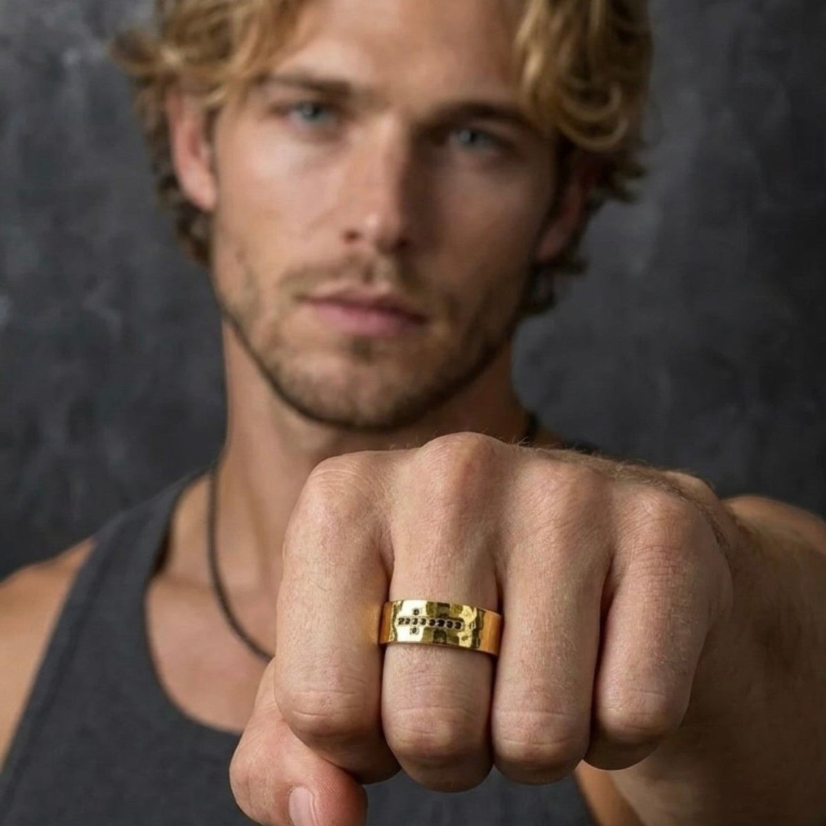 Bruttall RAW cross ring in matte gold with Swarovski Zirconia worn by a man with a textured, urban design