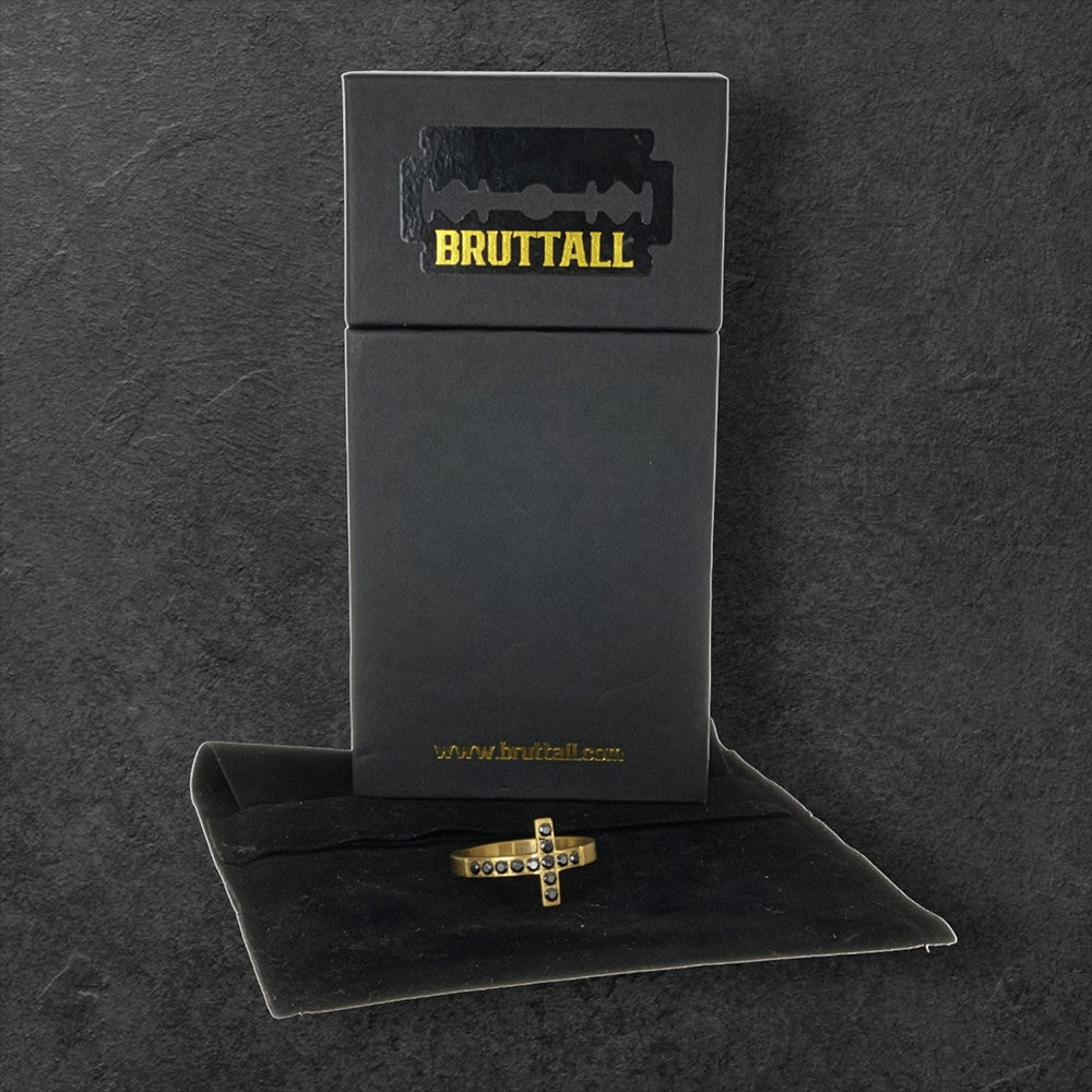 Bruttall TOWER cross ring in matte gold featuring black Swarovski crystals in a bold, architectural design.