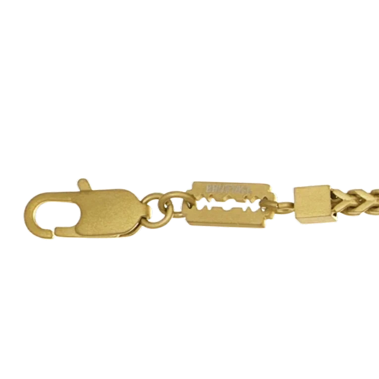 Bruttall CORE bracelet featuring gold-plated chain links and a row of faceted black Swarovski crystals