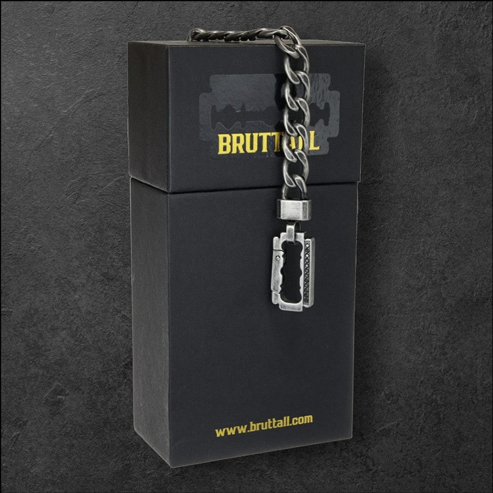 Bruttall AXIS chain bracelet in antique black with Swarovski Zirconia, displayed on a branded black gift box.