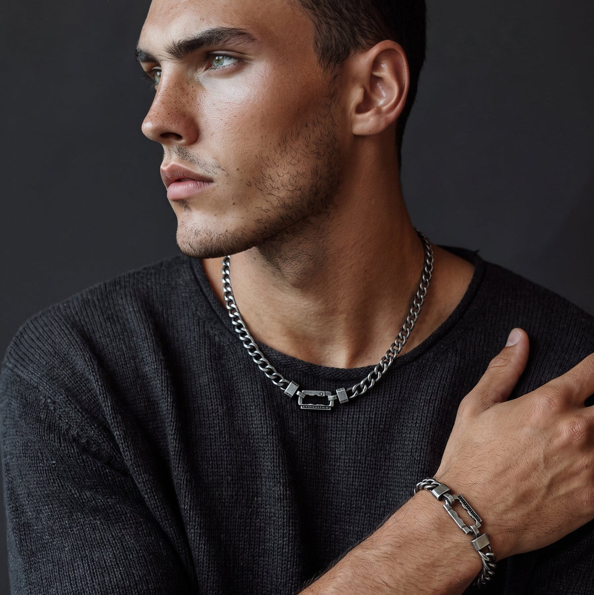 Bruttall AXIS chain in antique black with Swarovski Zirconia, worn by a man in a dark sweater.
