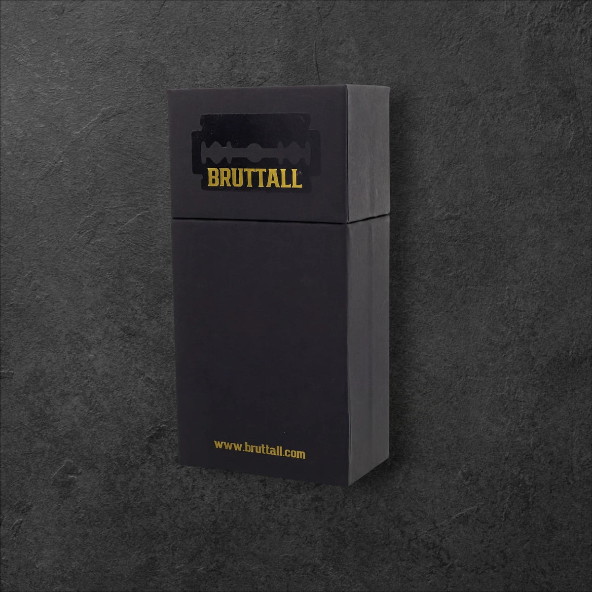 Bruttall branded black rectangular product packaging box with a razor blade logo on a dark textured background