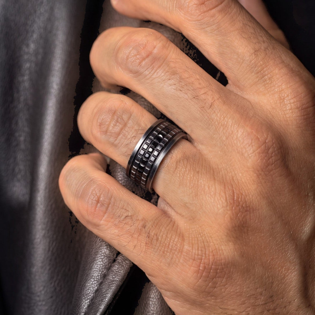 Bruttall GATE ring in antique black with a textured geometric pattern and embedded Swarovski crystals on a hand