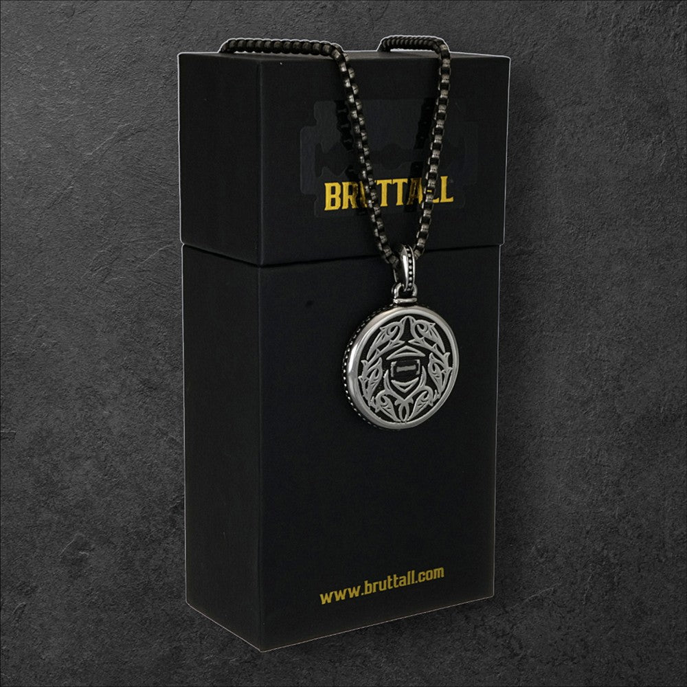 Bruttall gothic pendant with intricate silver detailing and Swarovski Zirconia on a black chain, displayed on a box.