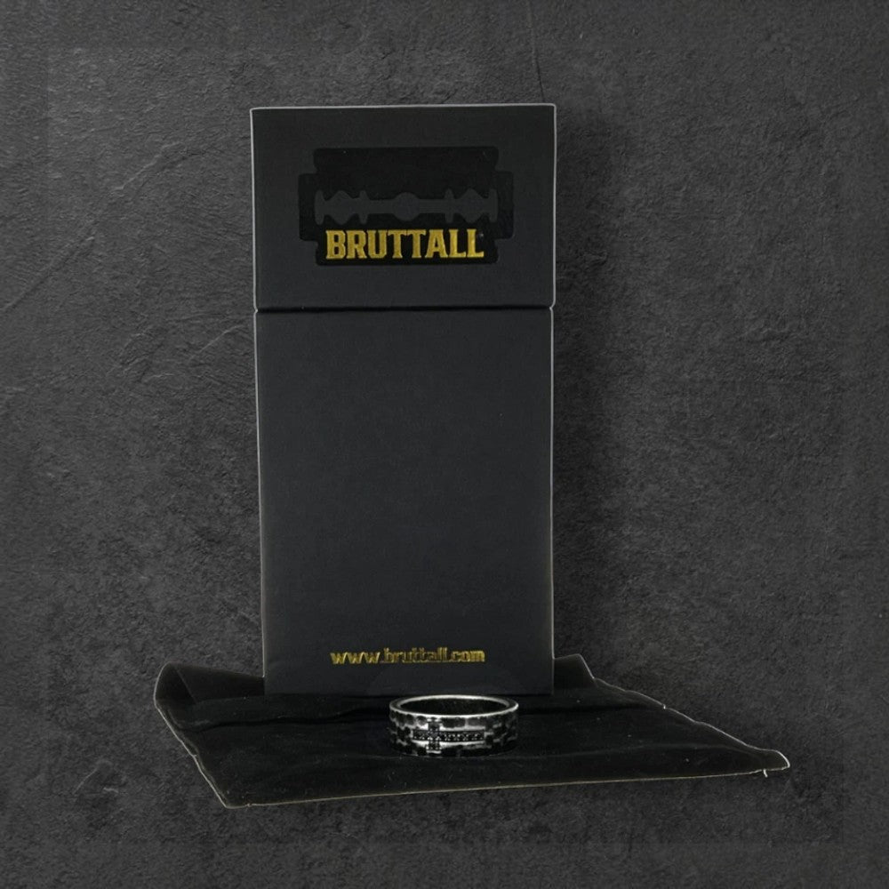 Bruttall RAW cross ring in antique black featuring Swarovski Zirconia, displayed with its branded black gift box.