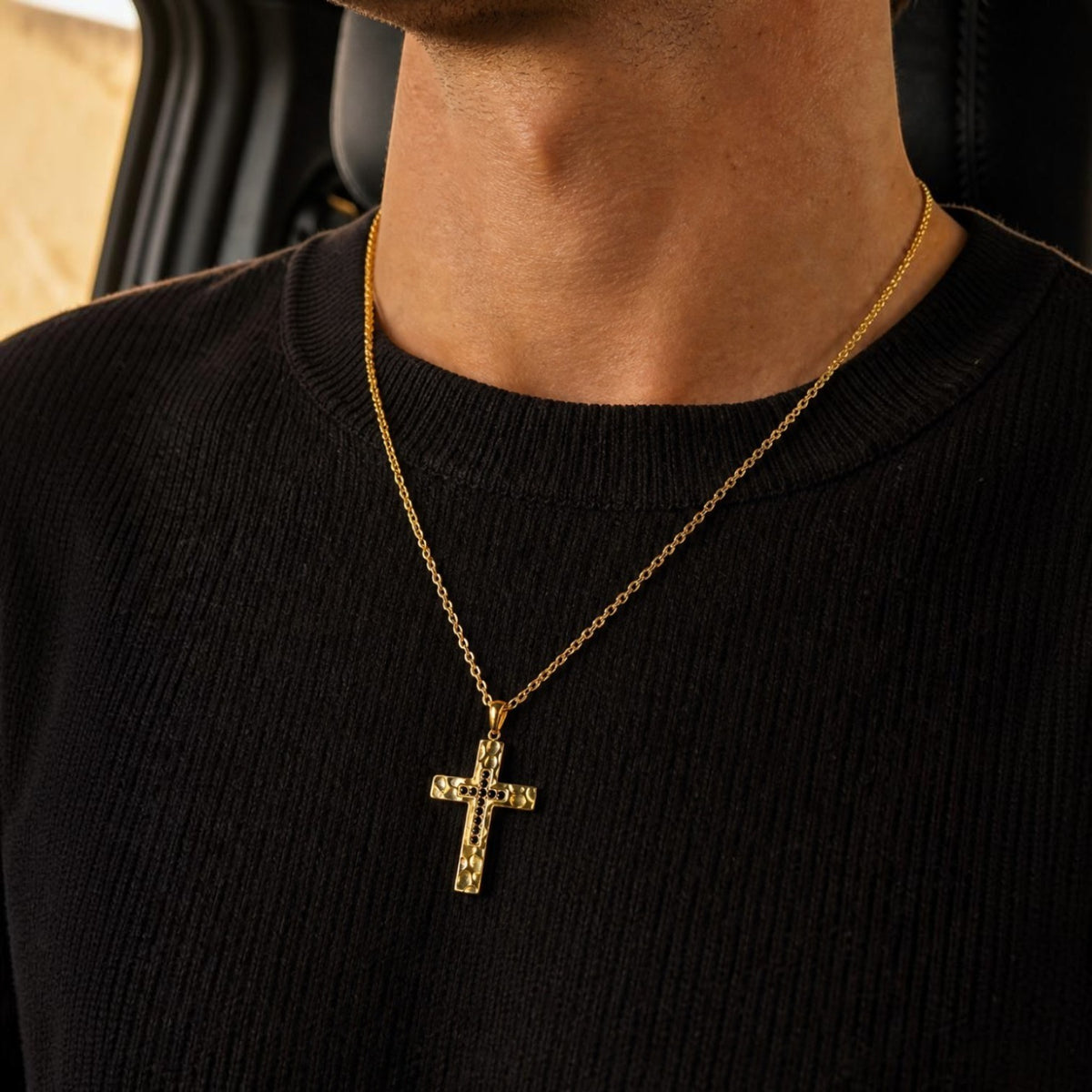 Bruttall RAW cross pendant in matte gold with textured stone-like finish and black Swarovski Zirconia on a chain