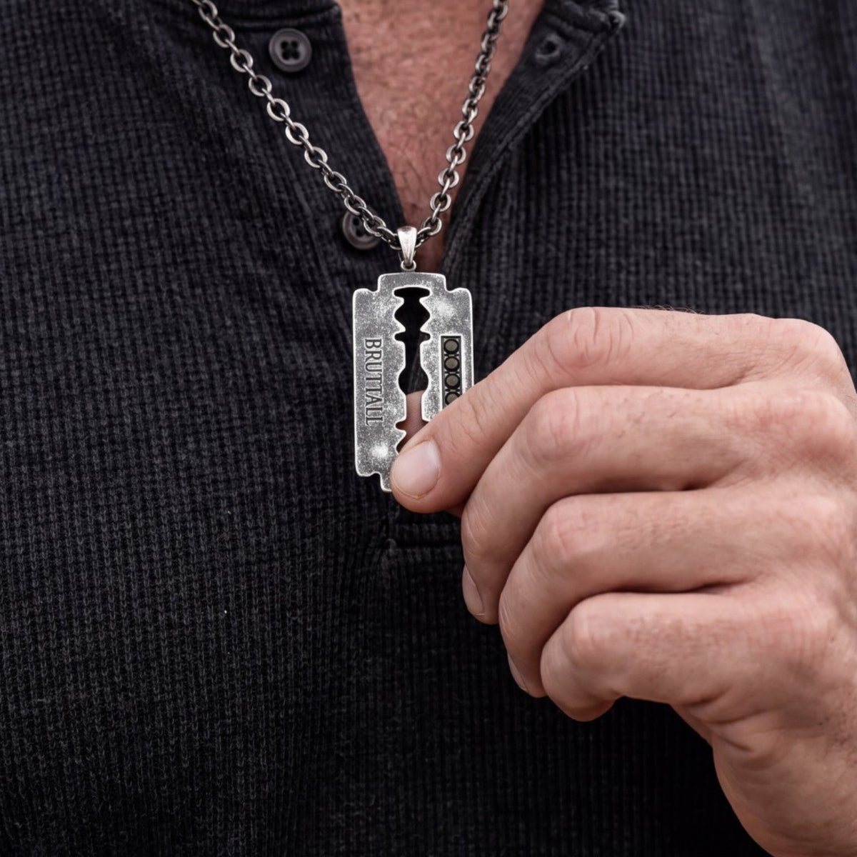 Bruttall RAZOR necklace featuring an antique black razor blade pendant with Swarovski crystals on a metal chain.