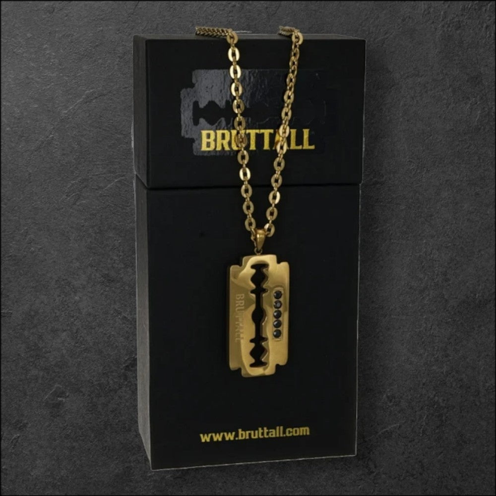 Bruttall RAZOR pendant necklace in matte gold with Swarovski crystals on a black branded display box
